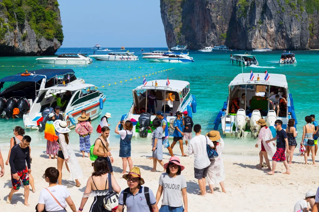 Maya Bay, seen above, made globally famous by the 2000 film The Beach, saw an influx of tourists that led to severe pollution and coral destruction. To address the environmental damage, authorities closed the bay to tourists for over three years. It reopened in 2022 with stricter regulations to protect its ecosystem.
